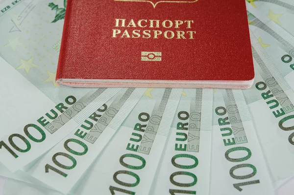 Passport in the background of one hundred Euro banknotes   in - time to travel — Stock Photo, Image
