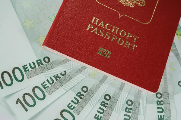 Passport in the background of one hundred Euro banknotes   in - time to travel — Stock Photo, Image