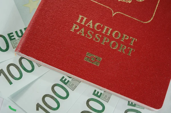 Passport in the background of one hundred Euro banknotes   in - time to travel — Stock Photo, Image