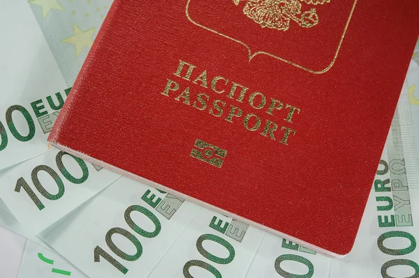Passport in the background of one hundred Euro banknotes   in - time to travel — Stock Photo, Image
