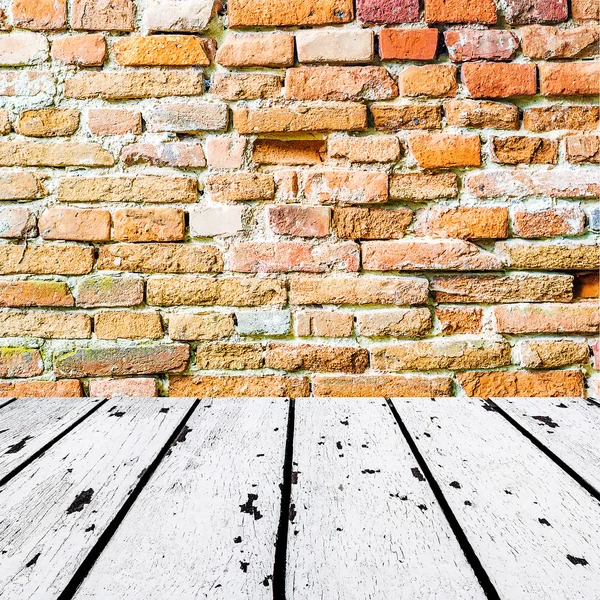 White wooden floor and orange brick wall — Stock Photo, Image