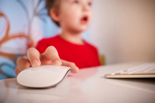 young boy playing with computer at night with blurred face