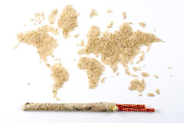 Map of the world made of raw natural rice on white background with chopsticks clipart