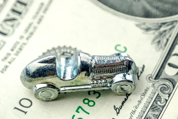 Little car made of chrome is laying on one dollar banknote — Stock Photo, Image