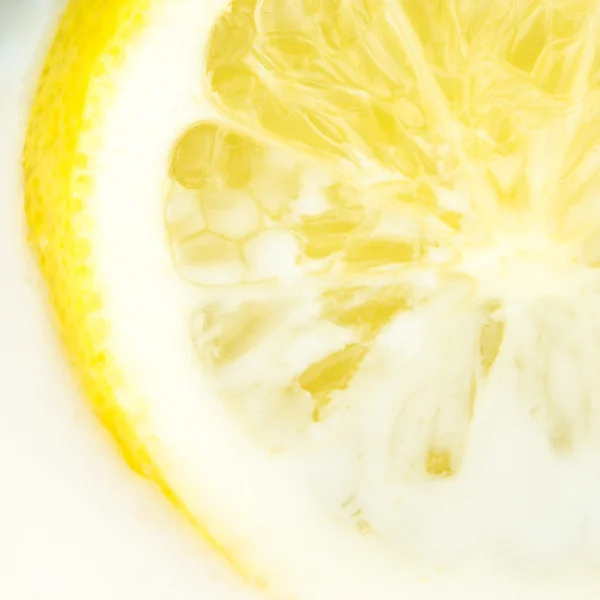Closeup view of lemon dipped in milk — Stock Photo, Image