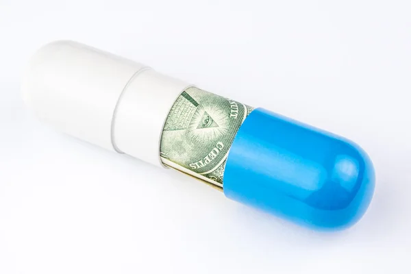 Satu dolar uang kertas digulung menjadi kapsul biru dan putih besar — Stok Foto