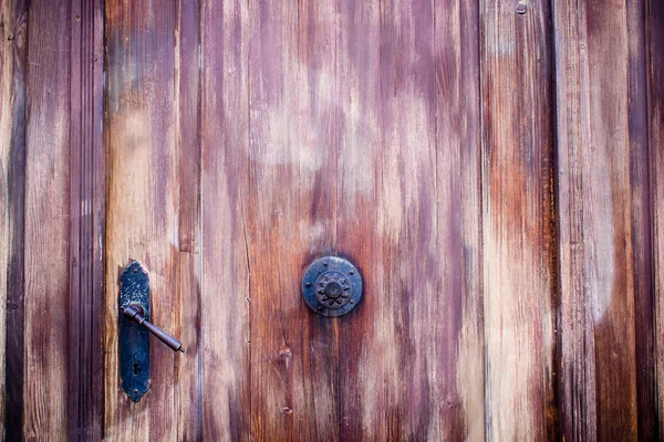 Old wooden door in vignetting vintage style — Stock Photo, Image