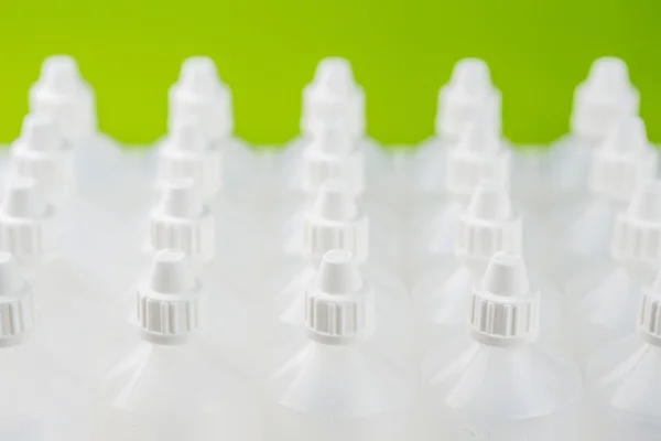 White translucent bottles used in homeopathy with blurred background — Stock fotografie