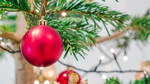 Glittering red christmas ball and other ornaments — Stock Photo, Image