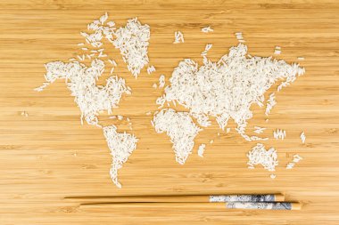 map of the world made of white rice with two bamboo sticks clipart