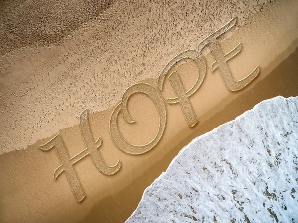 Håb skrevet på stranden - Stock-foto