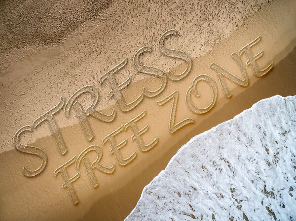 Stress Free Zone written on the beach