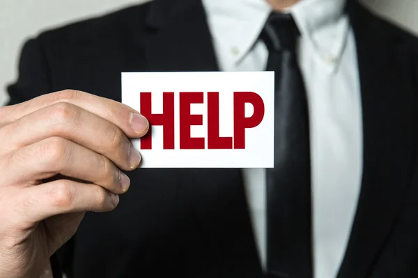 Businessman holding card with text — Stock Photo, Image