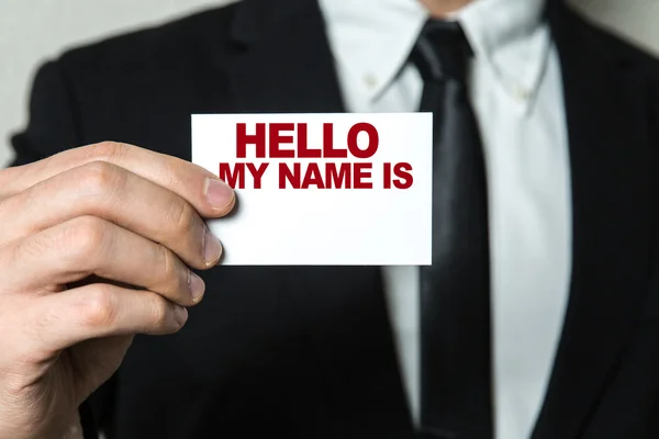 Businessman holding card with text — Stock Photo, Image