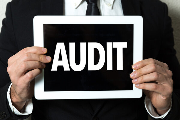 Businessman holding tablet with text