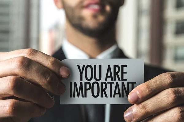 Businessman holding card with text — Stock Photo, Image