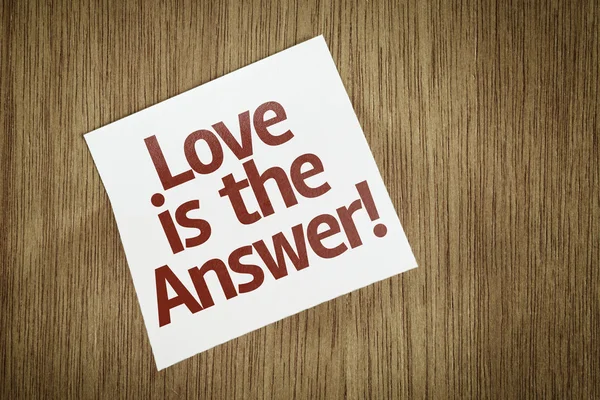 Love is the Answer! on Paper Note on texture background — Stock Photo, Image