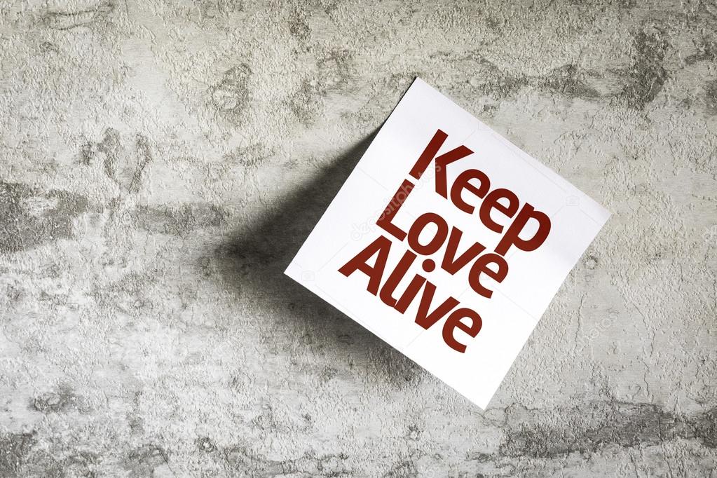 Keep Love Alive on Paper Note on texture background