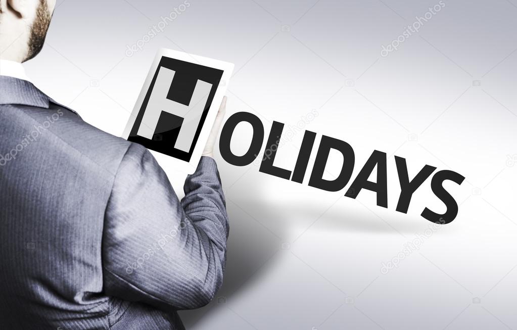 Business man with the text Holidays in a concept image