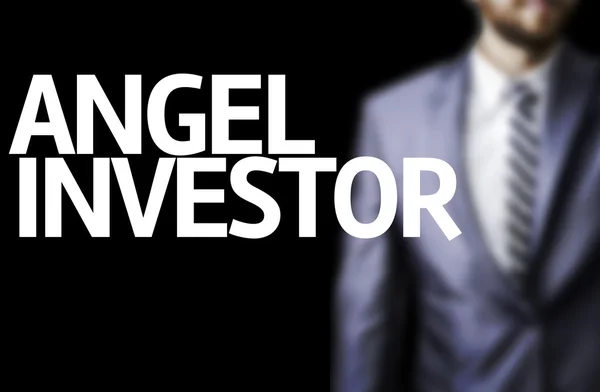 Angel Investor escrito em um conselho com um homem de negócios em segundo plano — Fotografia de Stock