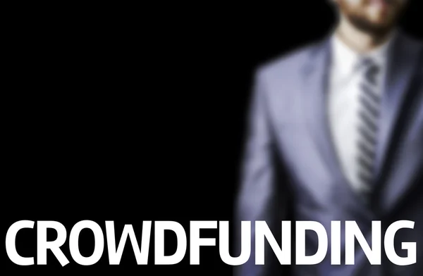 Crowdfunding written on a board with a business man — Stock Photo, Image