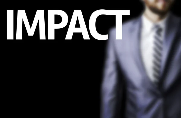 Impact written on a board with a business man — Stock Photo, Image