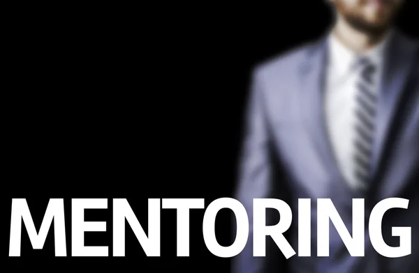 Mentoring written on a board with a business man — Stock Photo, Image