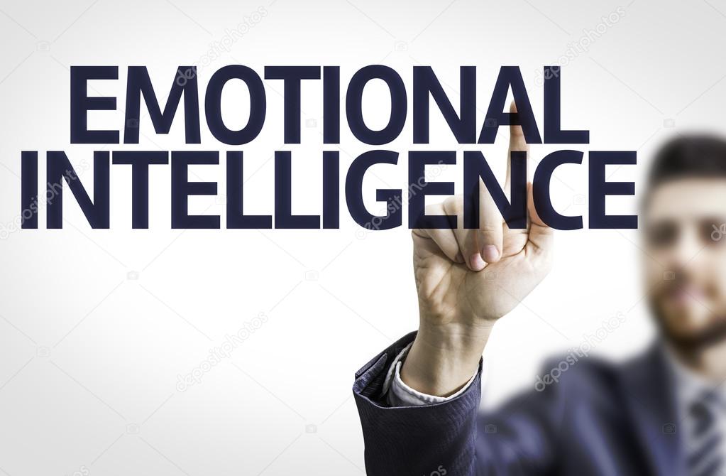 Business man pointing to transparent board with text: Emotional Intelligence