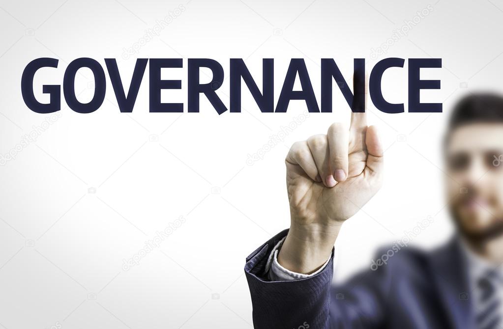Business man pointing to transparent board with text: Governance