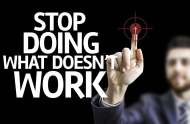 Business man pointing the text: Stop Doing What Doesn't Work clipart