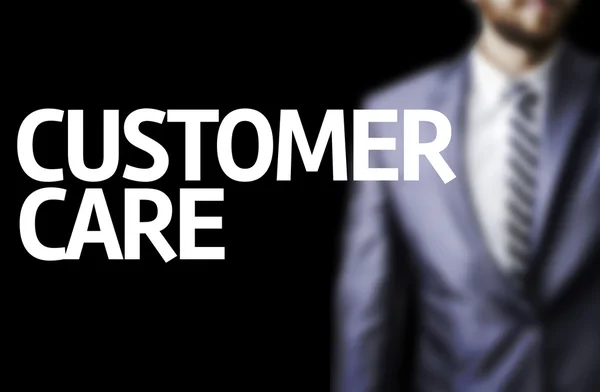 Customer Care written on a board with a business man — Stock Photo, Image