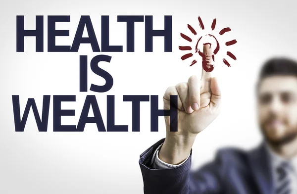 Deska s textem: zdraví je bohatství — Stock fotografie