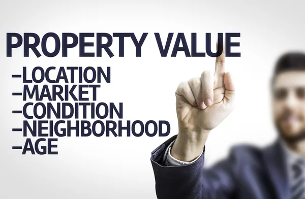 Business man pointing the text: Property Value — Stock Photo, Image