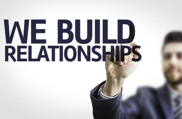 Business man pointing the text: We Build Relationship — Stock Photo, Image