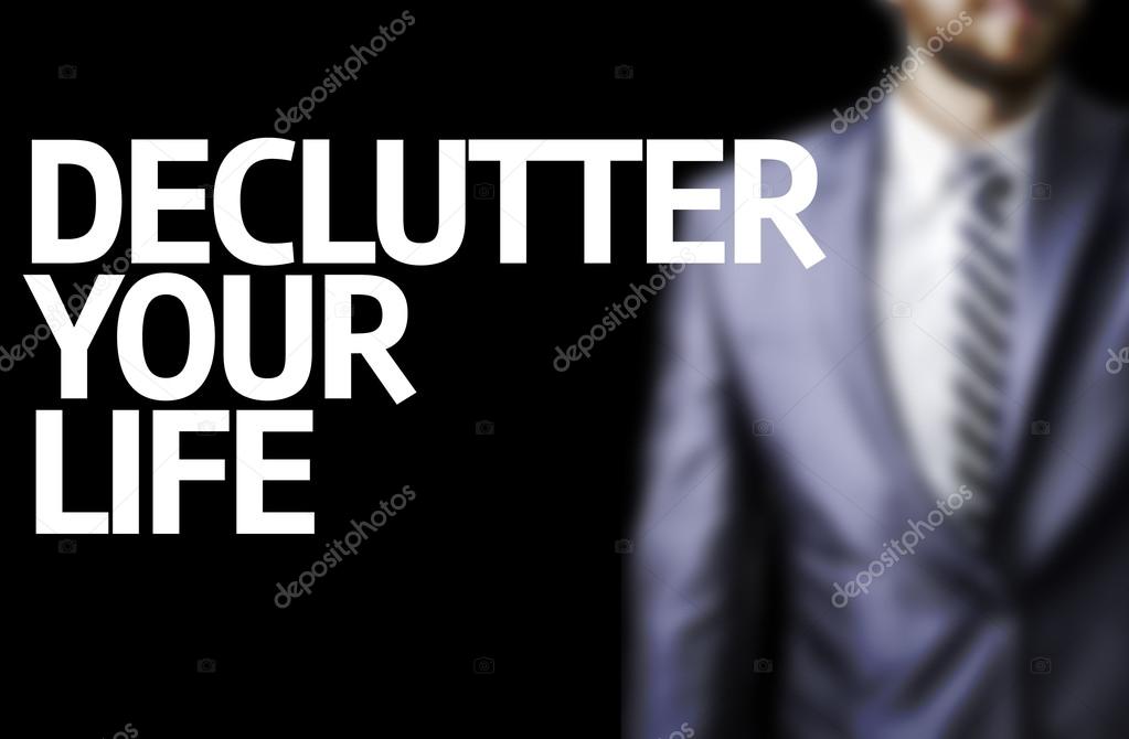 Declutter Your Life written on a board with a business man