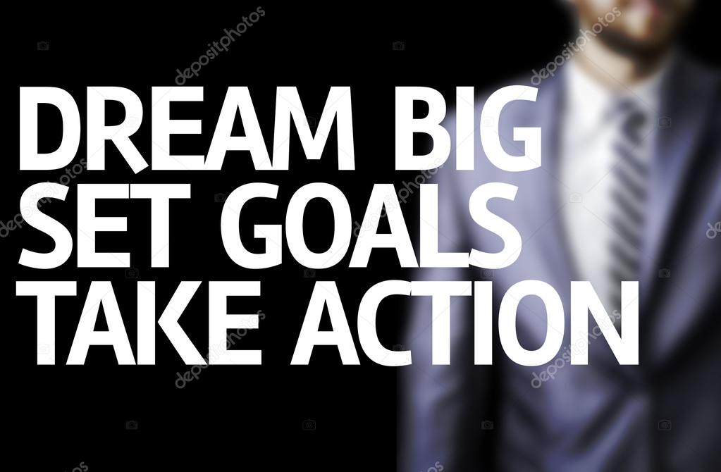 Dream Big Set Goals Take Action written on a board