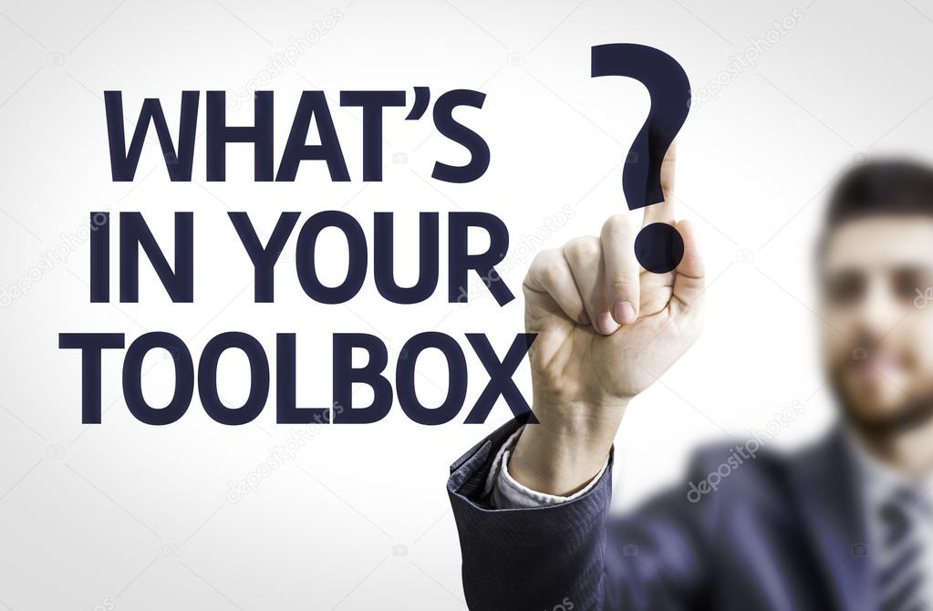 Business man pointing the text: What's In Your Toolbox?