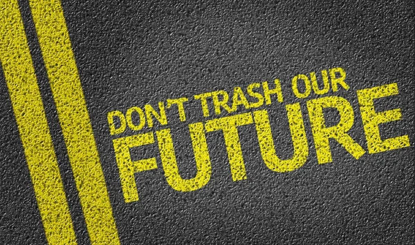 Don 't Trash Our Future written on the road — стоковое фото