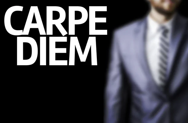 Carpe Diem written on a board with a business man — Stock Photo, Image