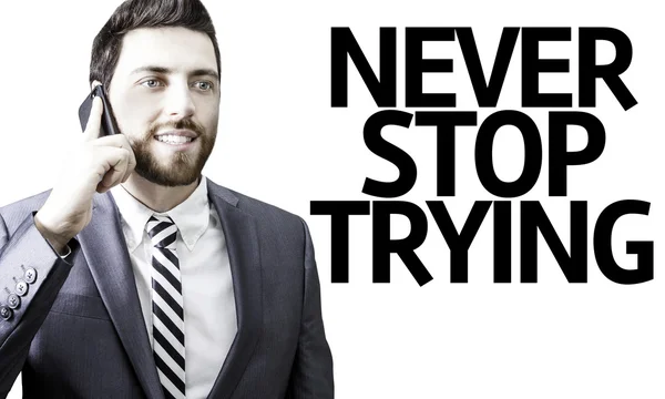 Hombre de negocios con el texto Never Stop Trying in a concept image —  Fotos de Stock