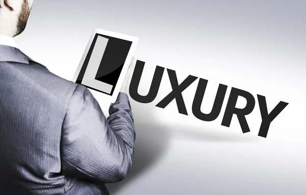 Homme d'affaires avec le texte Luxe dans une image concept — Photo