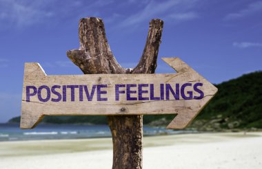 Positive Feelings wooden sign with a beach on background clipart