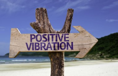 Positive Vibration wooden sign with a beach on background clipart