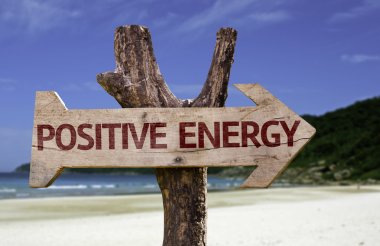 Positive Energy wooden sign with a beach on background clipart