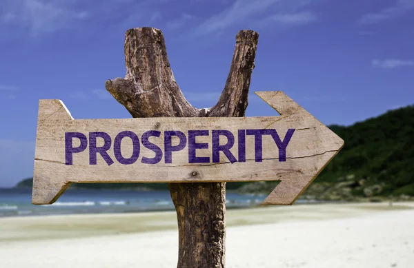 Prosperity wooden sign with a beach on background — Stock Photo, Image