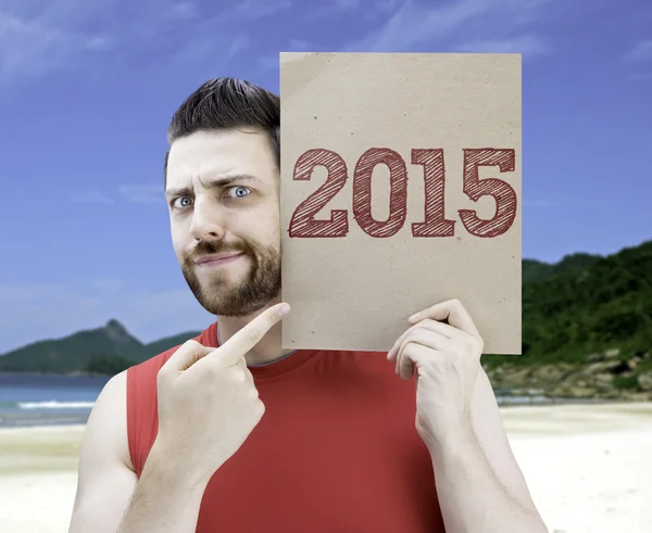 Hombre sosteniendo una tarjeta con el texto 2015 —  Fotos de Stock