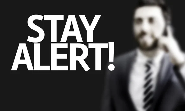 Hombre de negocios con el texto Stay Alert — Foto de Stock