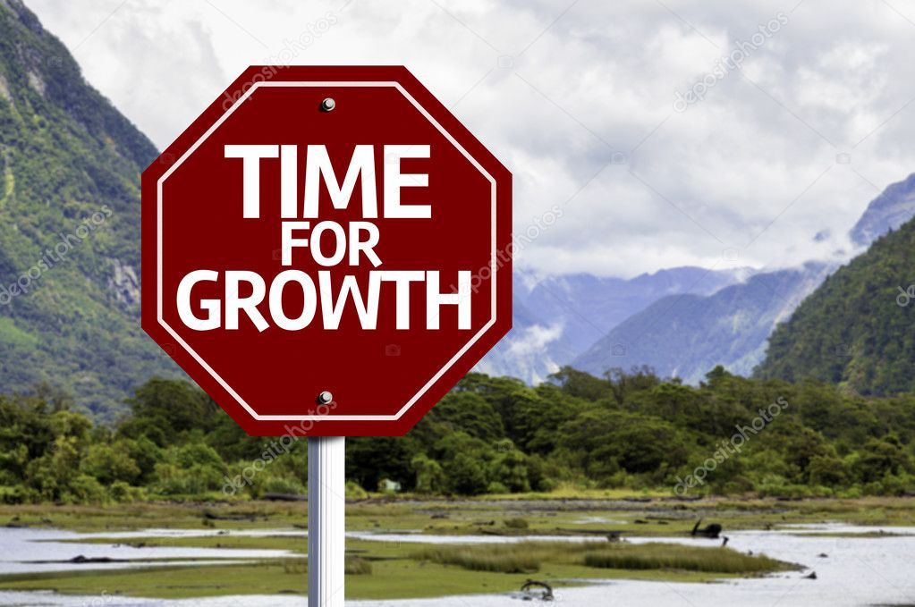 Time For Growth written on red road sign