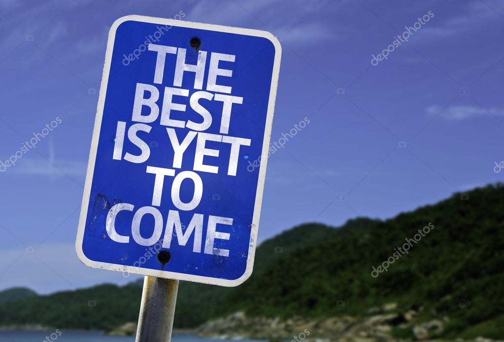 The Best Is Yet to Come sign with a beach on background