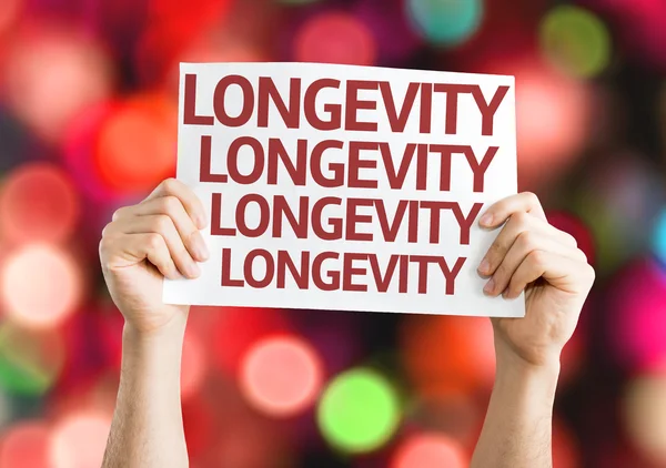Longevity card in hands — Stock Photo, Image